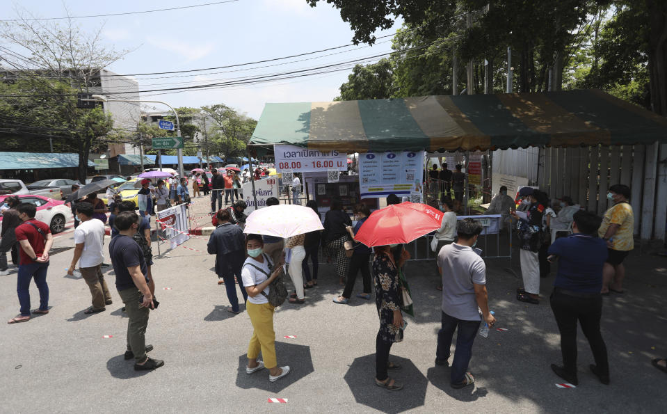 Peoples line up for a coronavirus test in Bangkok, Thailand, Friday, April 23, 2021. Thailand’s health authorities announced Friday they have confirmed just over 2000 new COVID-19 cases, a new daily record that brings the country's total to 50,183. (AP Photo/Nathatida Adireksarn)