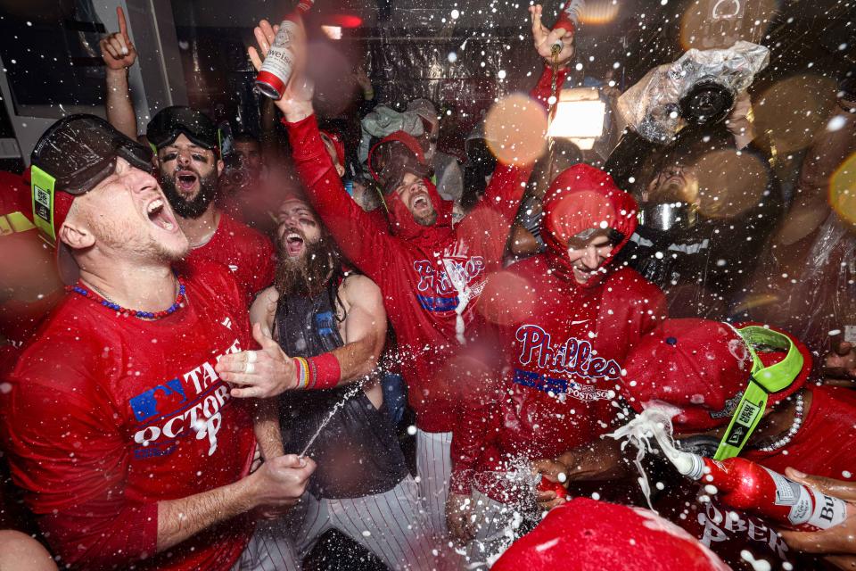 The Philadelphia Phillies celebrate in the locker room after defeating the Miami Marlins.