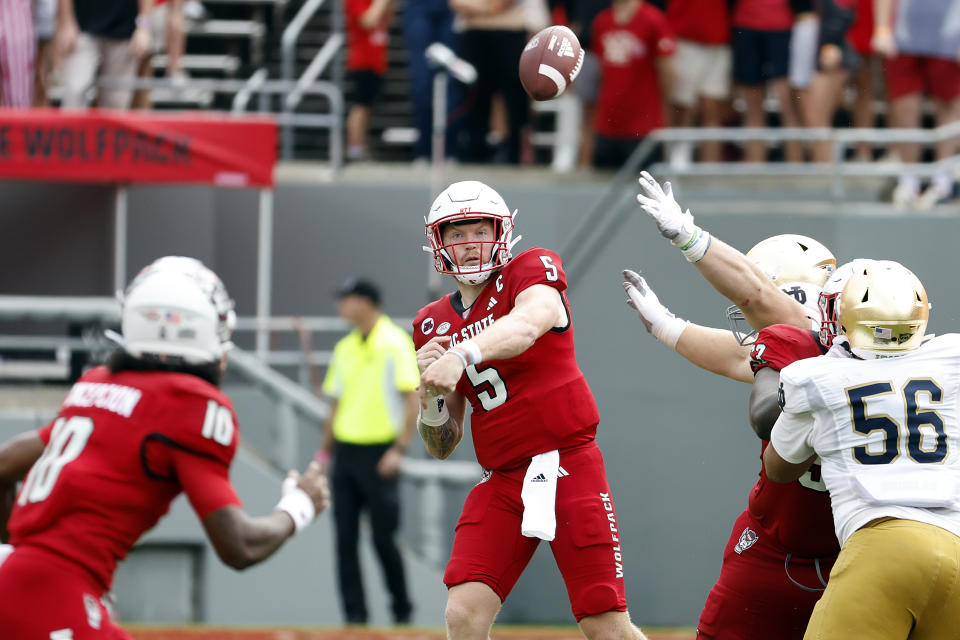 North Carolina State quarterback Brennan Armstrong (5) attempts to pass the ball to Kevin Concepcion (10) during the first half of an NCAA college football game against Notre Dame in Raleigh, N.C., Saturday, Sept. 9, 2023. (AP Photo/Karl B DeBlaker)