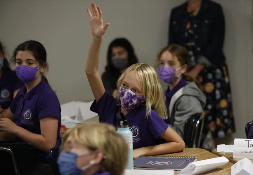 LOS ANGELES, CA - AUGUST 16: Sixth grade student Aria Kilhoffer answers a question in teacher Kelsey McFadden's class at the Girls Academic Leadership Academy: Dr. Michelle King School for STEM students on the first day of in-class instruction on August 16. LAUSD officials welcomed students, teachers, principals, at various school sites across Los Angeles. For the younger students it will be their first time in a classroom. Dr. Michelle King School for STEM on Monday, Aug. 16, 2021 in Los Angeles, CA. (Al Seib / Los Angeles Times).