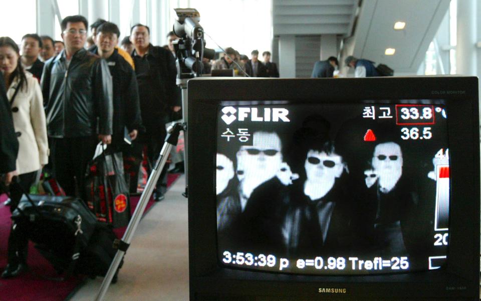 A thermal camera monitors the body temperature of passengers arriving from Taipei against the possible infection of the flu-like Severe Acute Respiratory Syndrome (SARS) at Incheon International Airport, west of Seoul in 2003.