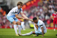 Crystal Palace's Joachim Andersen, left, helps to Crystal Palace's Nathaniel Clyne during the English Premier League soccer match between Liverpool and Crystal Palace at Anfield Stadium in Liverpool, England, Sunday, April 14, 2024. (AP Photo/Jon Super)