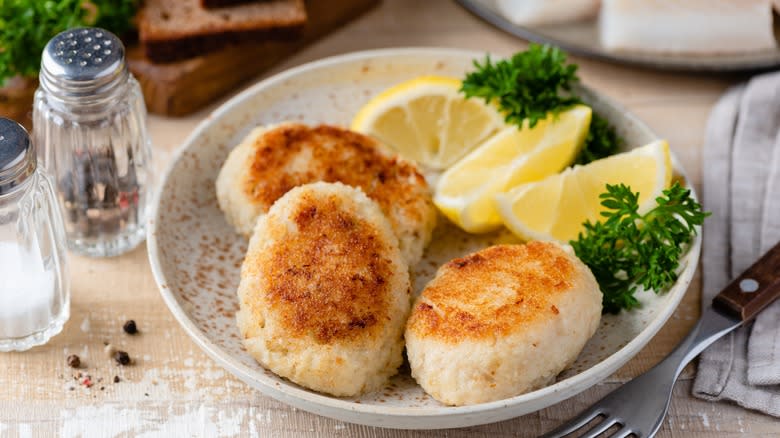 Plate of salmon patties with lemons