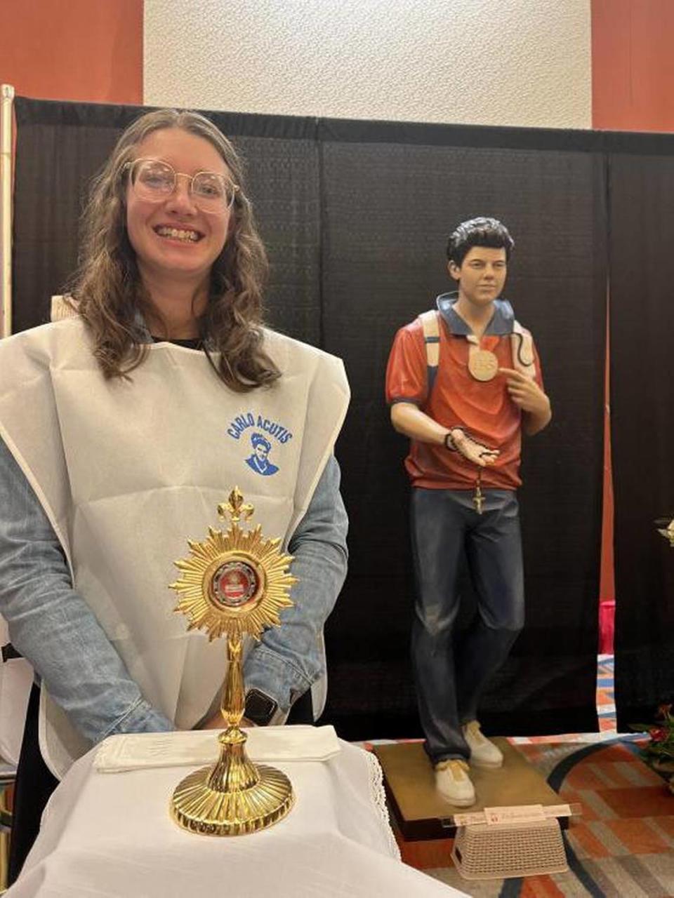 Volunteer Rachel Schuett stands near a relic of soon-to-be saint Carlo Acutis during a conference organized by the Archdiocese of Miami, which drew 4,000 people to Miami in 2022.