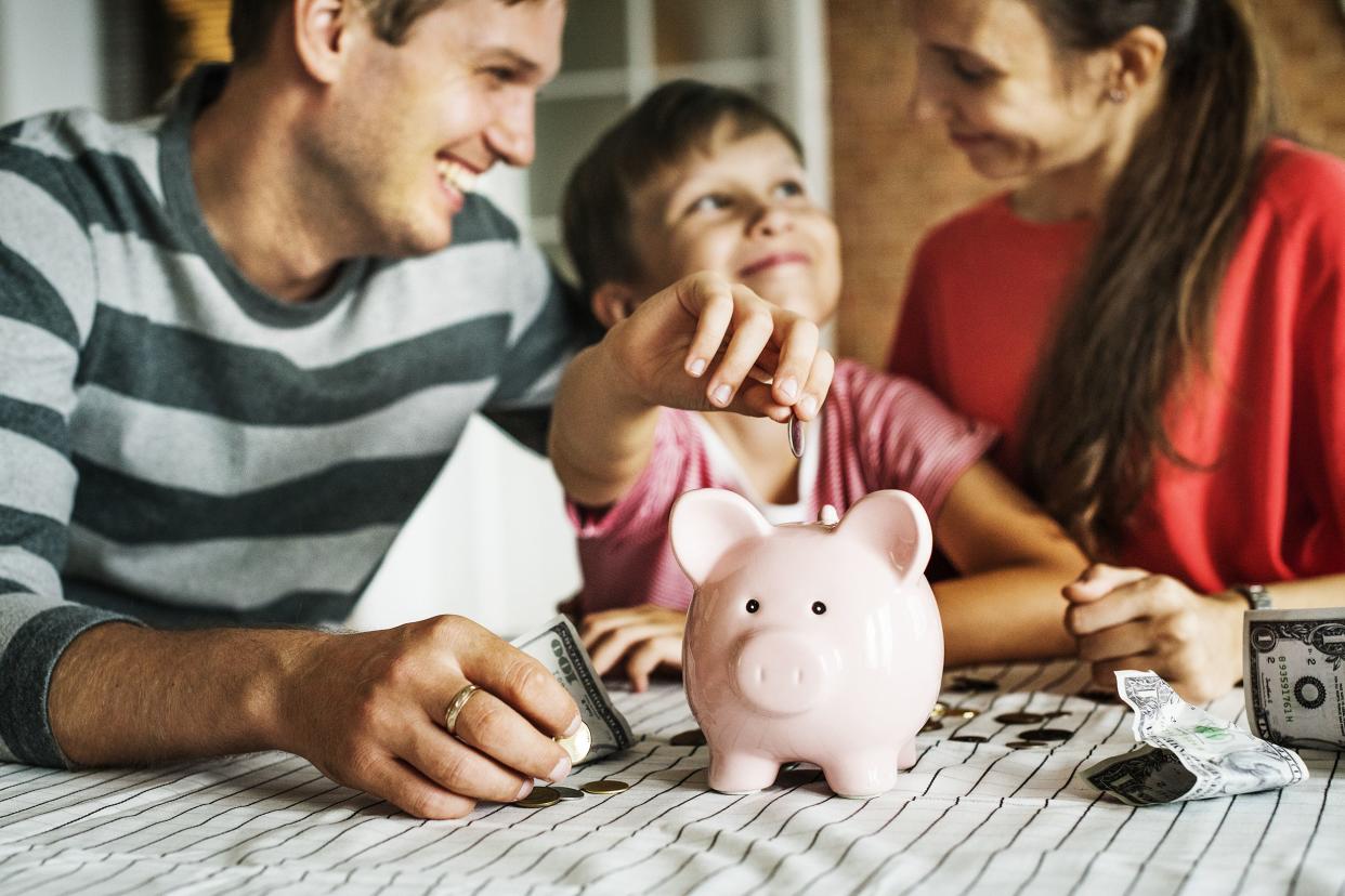family with money and piggy bank