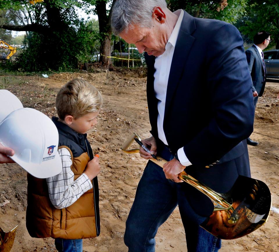 Judah Herriman, 6, watches as Tennessee Governor Bill Lee signs a shovel used in a groundbreaking ceremony for Rutherford Collegiate Prep (RCP) in Murfreesboro, Tenn. on Thursday, Oct. 12, 2023 after the program. This will be the first public charter school to be built in Rutherford County.