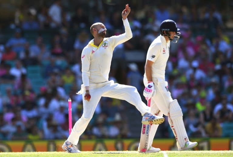 Australia's spinner Nathan Lyon (L) sends down a delivery watched by England's batsman Joe Root (R) on the fourth day of the fifth Ashes Test