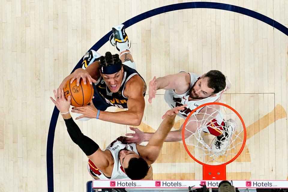 Game 2: Denver Nuggets forward Aaron Gordon (50) shoots the ball against Miami Heat guard Max Strus (bottom) and forward Kevin Love (right).