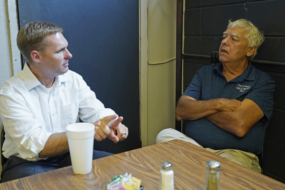 U.S. Rep. Michael Guest, R-Miss., left, confers with Magee Mayor Dale Berry, in Magee, Miss., June 16, 2022, as he seeks support for his runoff race against former Navy pilot Michael Cassidy in the Republican primary of Mississippi's 3rd Congressional District.(AP Photo/Rogelio V. Solis)