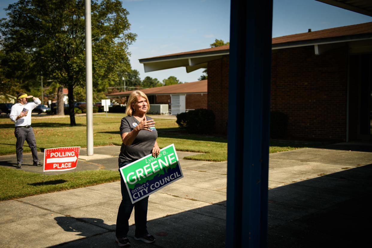 City Council District 5 candidate Lynne Greene speaks to voters as they go into Glendale Acres Elementary School to vote on Tuesday, Oct. 10, 2023.