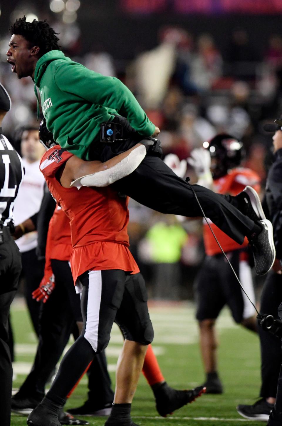 Texas Tech linebacker Kosi Eldridge gives graduate assistant Jah'Shawn Johnson a lift as the Red Raiders celebrate their overtime victory over Oklahoma in November 2022. Johnson is completing his second year on the Tech staff after he was a four-year starter at safety from 2015-18.