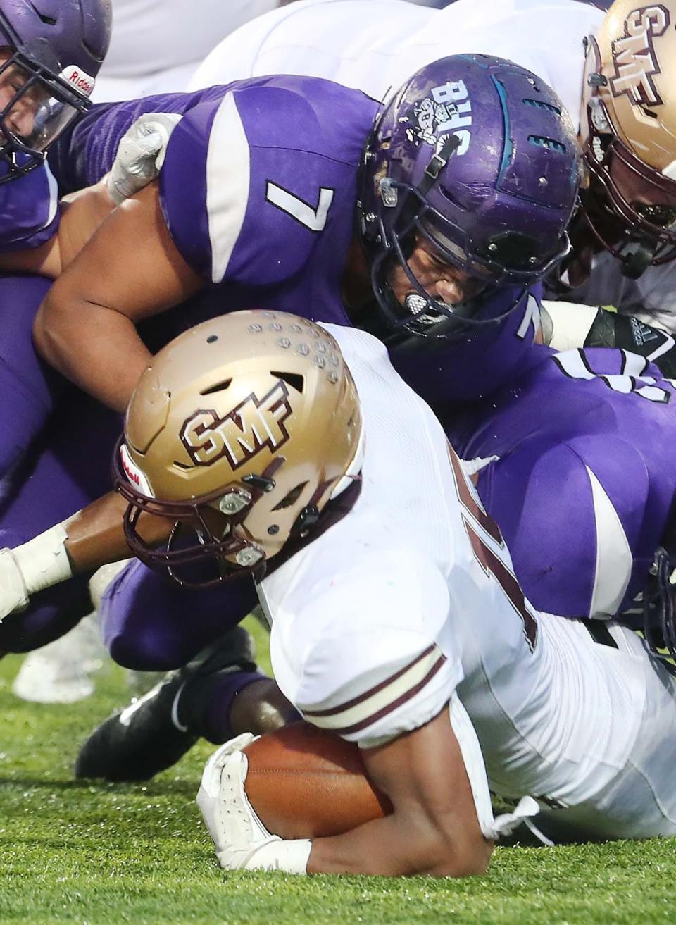 Barberton's John Jackson, top, tackles Stow's Xavier Preston during the first half of their game at Barberton High School Friday, Aug. 27, 2021 in Barberton, Ohio.