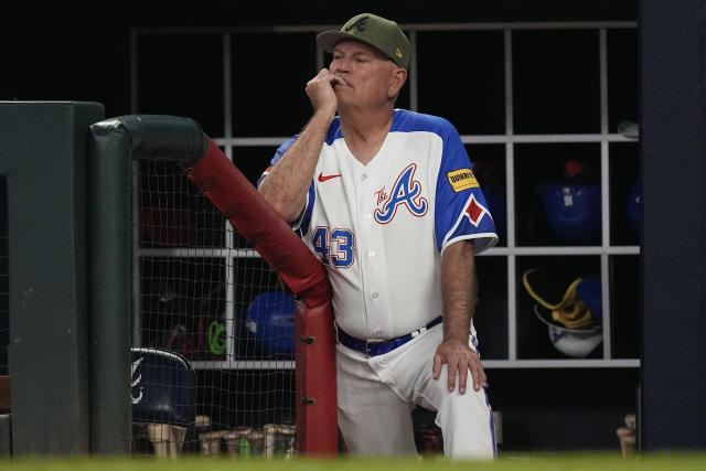 Atlanta Braves manager Brian Snitker watches from the dugout during a baseball game against the Seattle Mariners, Saturday, May 20, 2023, in Atlanta. (AP Photo/John Bazemore)