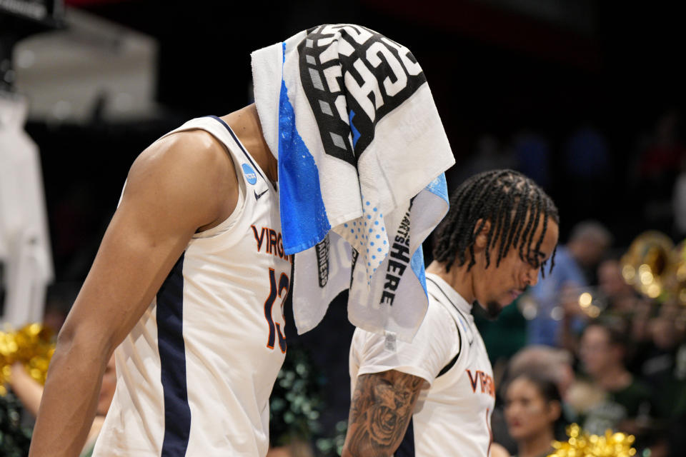Virginia's Ryan Dunn (13) and Dante Harris walk off of the court after being defeated by Colorado State in a First Four college basketball game in the NCAA Tournament in Dayton, Ohio, Tuesday, March 19, 2024. (AP Photo/Jeff Dean)