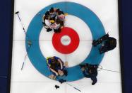 Curling - Pyeongchang 2018 Winter Olympics - Women's Final - Sweden v South Korea - Gangneung Curling Center - Gangneung, South Korea - February 25, 2018 - Agnes Knochenhauer of Sweden is embraced by her teammates as they celebrate in front of South Korea's players after winning the final. REUTERS/Cathal McNaughton