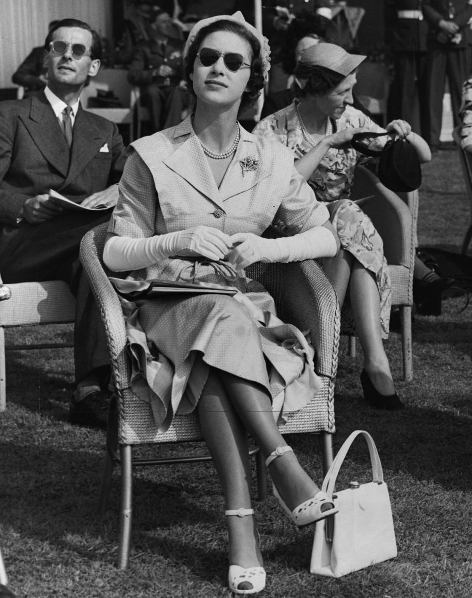 <p>Princess Margaret watches a Royal Air Force display at Farnborough in 1950, wearing more casual attire.</p>