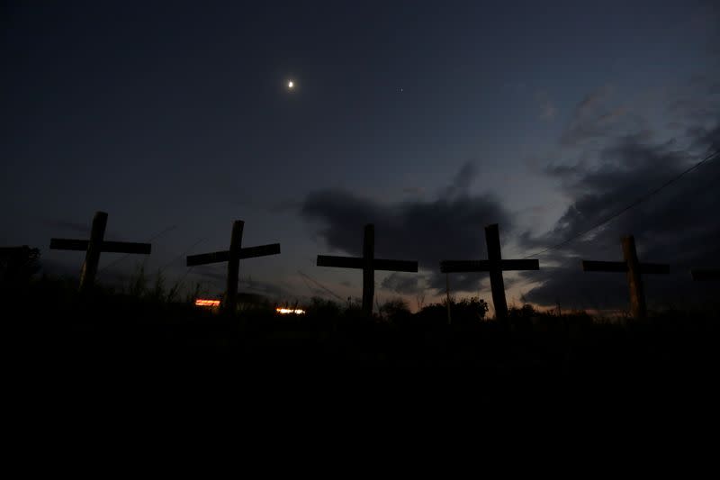 Crosses that represent 65 miners who died during an explosion in 2006 in Pasta de Conchos coal mine, are seen along a highway in San Juan de Sabinas