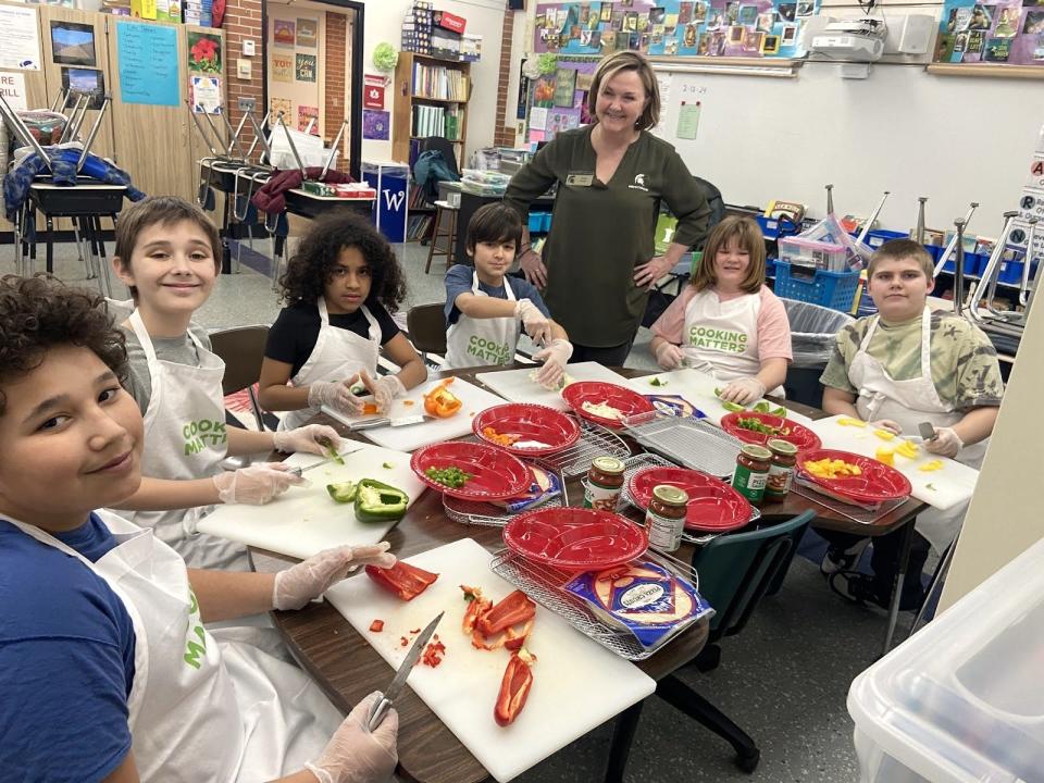 Michener Elementary School is able to offer a Cooking Club for fourth and fifth grade students because of a grant from Michigan State University Extension and Meijer. Pictured during a recent Cooking Club session are, from left, Treyvion Newsom, Jax Nichols, Anna Monroe, Calvin Baker, Vickie Pfeifer with MSU Extension, Abigail Underwood and Caleb Sheldon.