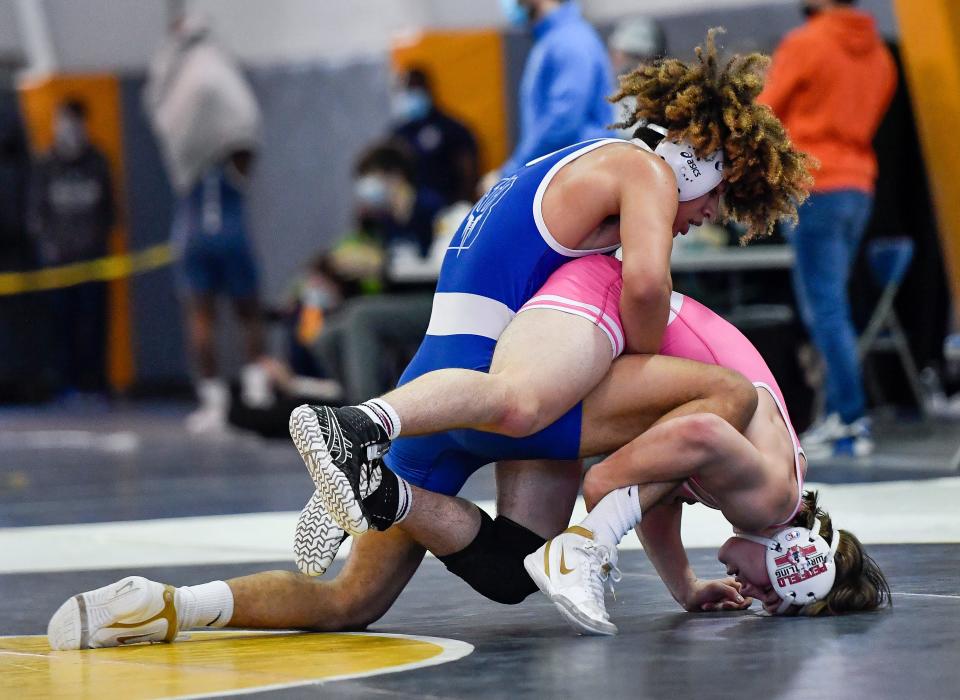 Brockport's Isaiah Rodriguez, top, wrestles Penfield's Dominick Porto in the final of the 152-pound weight class during the Section V Class A2 Championships at Webster Thomas High School, Saturday, Mar. 13, 2021.