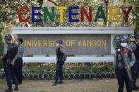 Riot police officers stand guard during a rally against the military coup at the University of Yangon