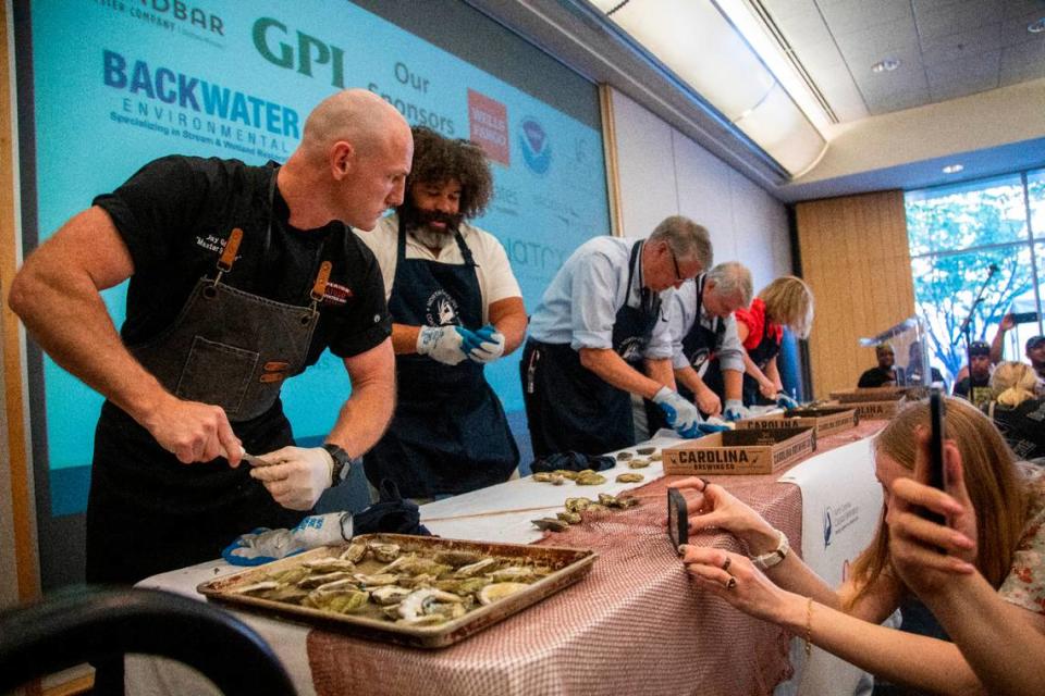 Jay Gallet, the nation’s fastest oyster-shucker, left, competes during NC Oyster Summit, Tuesday, May 9, 2023 at Marbles Kids Museum in Raleigh.