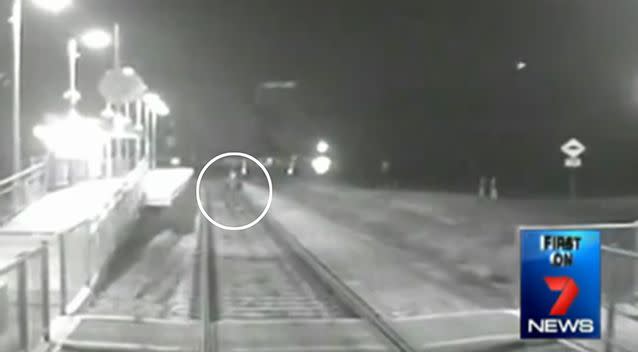 Shocking footage of a man standing in front of a coming train. Photo: 7 News