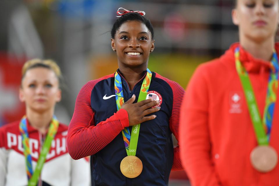 US gymnast Simone Biles (pictured middle) celebrates on the podium for the women's vault event final of the Rio 2016 Olympic Games.
