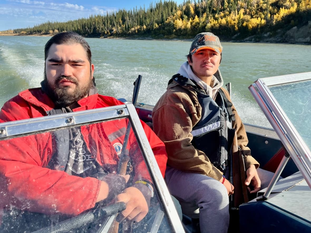 John Henderson III and Drayden Jobb say they learned about the water and the bush from their dads and uncles. Now they're passing on the knowledge to the next generation of Fox Lake Cree.  (Andrew Wildes/CBC - image credit)