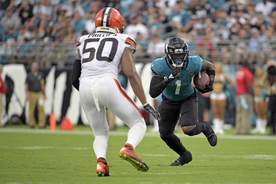 Jacksonville Jaguars running back Travis Etienne Jr. (1) looks to get past Cleveland Browns linebacker Jacob Phillips (50) during the first half of an NFL preseason football game, Friday, Aug. 12, 2022, in Jacksonville, Fla. (AP Photo/Phelan M. Ebenhack)