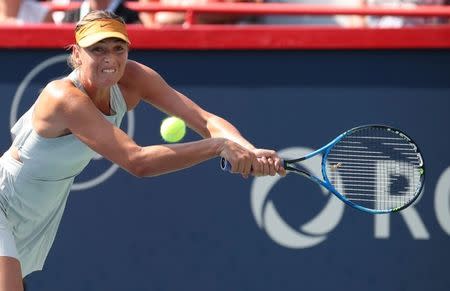 Aug 7, 2018; Montreal, Quebec, Canada; Maria Sharapova of Russia hits a shot against Sesil Karatantcheva of Bulgaria (not pictured) in the Rogers Cup tennis tournament at IGA Stadium. Mandatory Credit: Jean-Yves Ahern-USA TODAY Sports