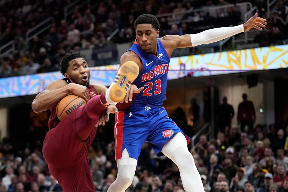 Cavaliers guard Donovan Mitchell, left, grabs a rebound in front of Pistons guard Jaden Ivey in the second half of the Pistons' 128-121 loss on Wednesday, Jan. 31, 2024, in Cleveland.