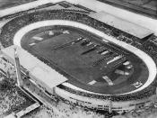 In this 1928 photo provided by the International Olympic Committee, the Olympic cauldron stands over the stadium in Amsterdam. The Olympic flame was introduced at the 1928 Amsterdam Olympics. The torch relay began eight years later ahead of the 1936 Berlin Games. (IOC via AP)