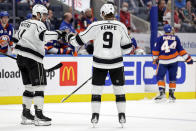 Los Angeles Kings center Adrian Kempe (9) is congratulated by Anze Kopitar after scoring an empty net goal in the third period of an NHL hockey game against the New York Islanders on Thursday, Jan. 27, 2022, in Elmont, N.Y. The Kings won 3-2. (AP Photo/Adam Hunger)