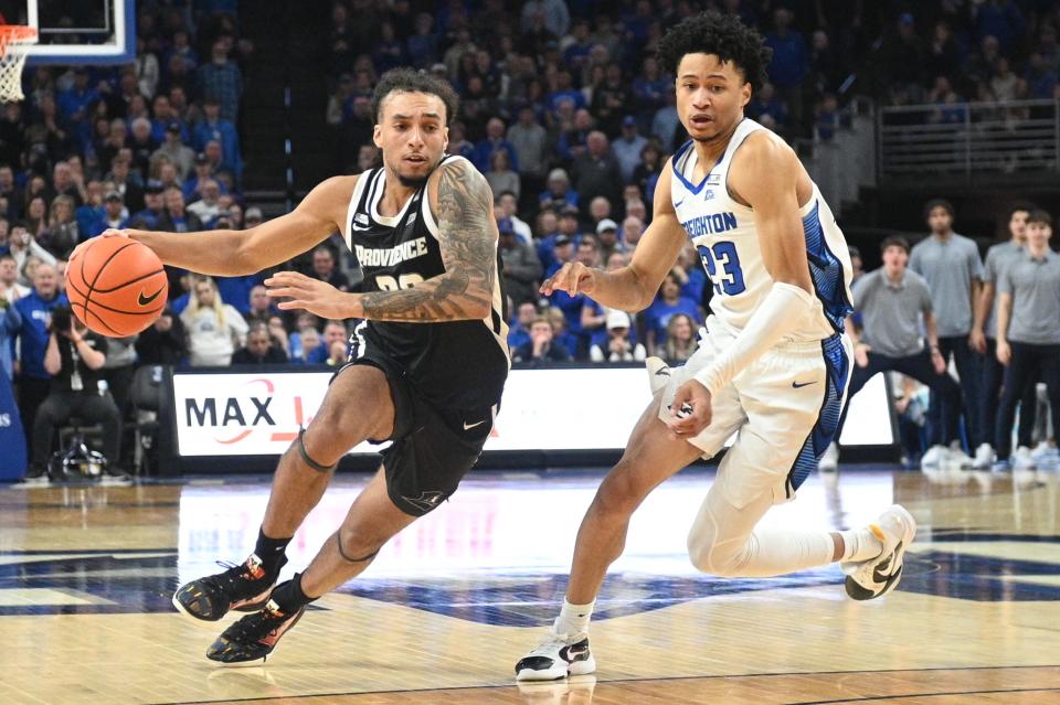 Friars guard Devin Carter, who led all scorers with 25 points, tries to drive past Bluejays guard Trey Alexander during Saturday's Big East game in Omaha.