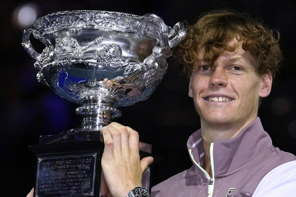 FILE - Jannik Sinner, of Italy, holds the Norman Brookes Challenge Cup aloft after defeating Daniil Medvedev, of Russia, in the men's singles final at the Australian Open tennis championships at Melbourne Park, in Melbourne, Australia, Sunday, Jan. 28, 2024. Sinner won his first Grand Slam title in January at the Australian Open and is one of the top men entered in the French Open, which starts Sunday at Roland Garros in Paris.(AP Photo/Andy Wong, File)