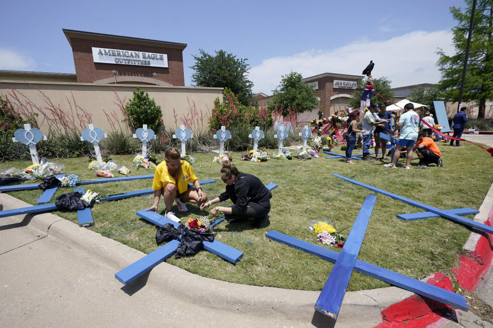 Large crosses are constructed at a makeshift memorial by the mall where several people were killed several days earlier, Monday, May 8, 2023, in Allen, Texas. (AP Photo/Tony Gutierrez)