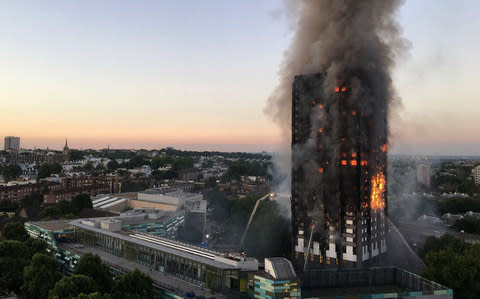 Smoke and flames rise from the Grenfell Tower - Credit: Natalie Oxford/AFP