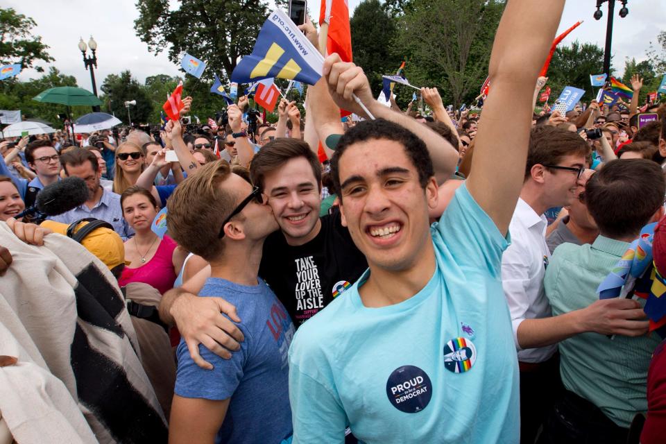 Supporters of same-sex marriage celebrate outside of the Supreme Court in Washington, Friday, June 26, 2015, after the court declared that same-sex couples have a right to marry anywhere in the U.S.