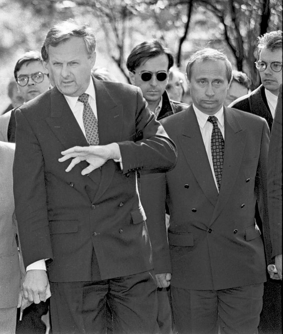 In this photo taken in 1994, Anatoly Sobchak, then the city mayor, St. Petersburg, left, gestures as Vladimir Putin, right, then St. Petersburg deputy mayor, stands next to him, during a city event in St. Petersburg, Russia.