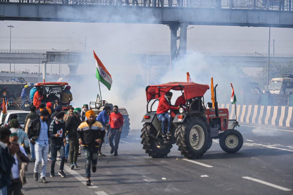 Police used tear gas to disperse farmers attempting to break barricades at Ghazipur border.