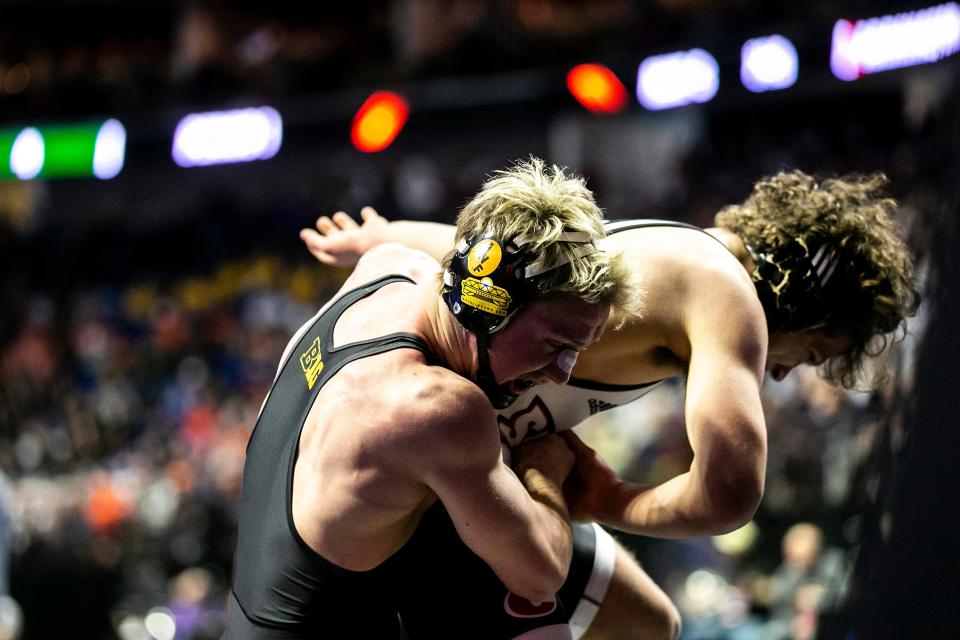 Iowa's Max Murin, left, wrestles Southern Illinois Edwardsville's Caleb Tyus at 149 pounds on Thursday at the NCAA Championships.
