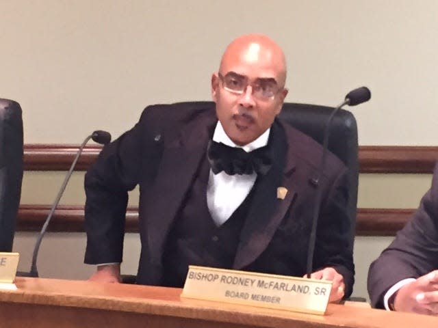 Board president Rodney McFarland settles into his seat before Tuesday’s Monroe City School Board meeting.