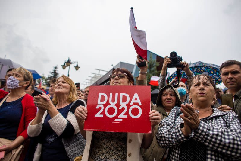 Supporters of Polish President Andrzej Duda listen to speeches during election rally in Kwidzyn