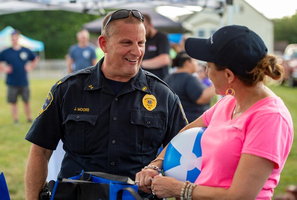 Bristol Borough Police Chief Joe Moors, left, chats with Rachel Dalinka, of Keystone First, during the National Night Out in Bristol Borough, which was held at the Snyder-Girotti Elementary School, on Tuesday, Aug. 2, 2022.