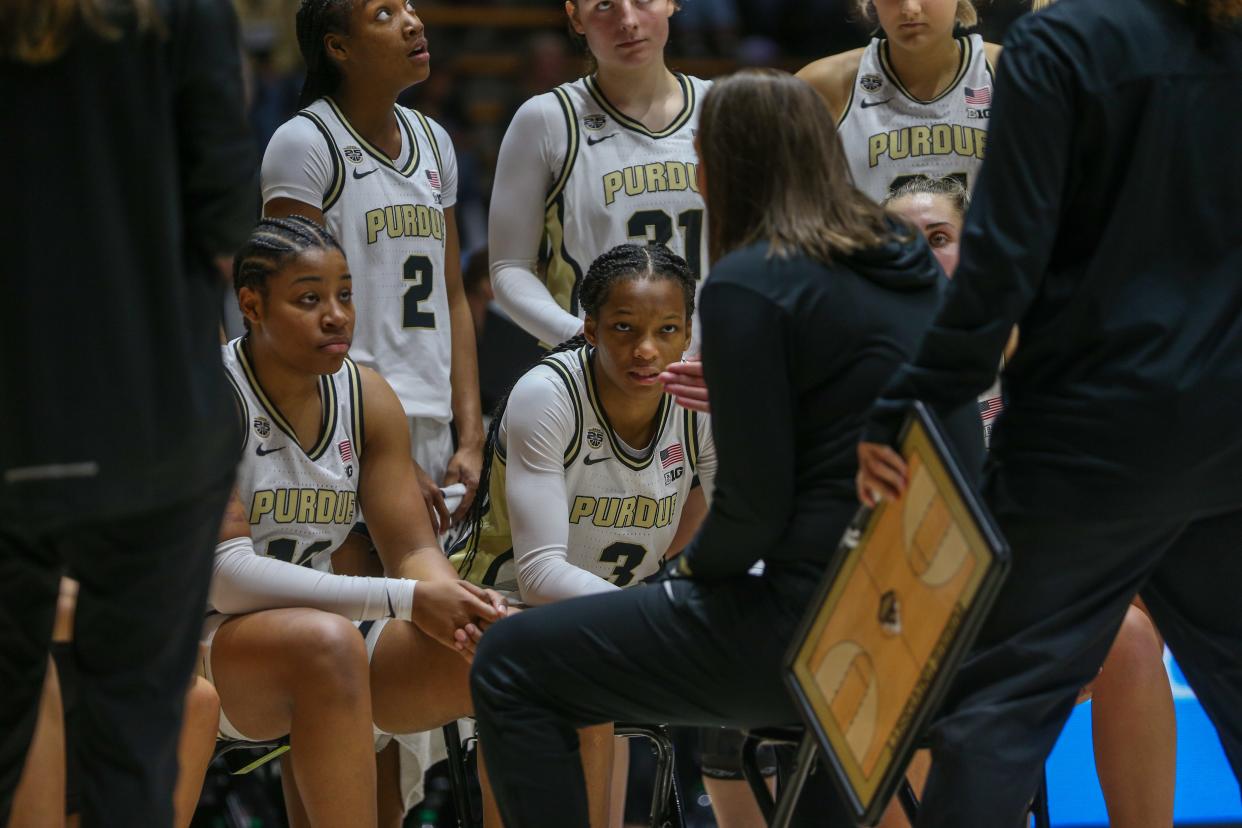 Purdue Boilermakers women’s team listens to Head Coach Katie Gearlds during a timeout during the NCAA women's basketball game against the Quincy Hawks, on Sunday, Oct. 29, 2023, at Mackey Arena in West Lafayette, Ind.