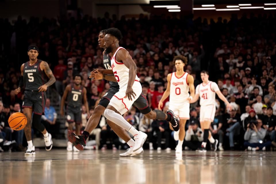 Bearcats guard John Newman chases down a loose ball in the first half. Newman, who came off the bench, scored 14 points, all in the second half.