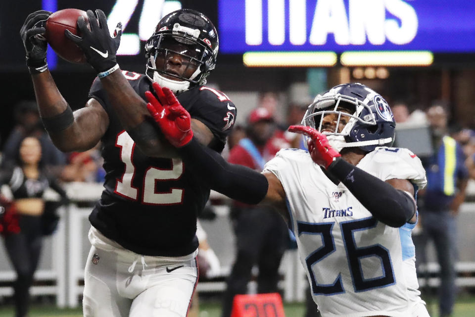 Atlanta Falcons wide receiver Mohamed Sanu (12) misses the catch against Tennessee Titans cornerback Logan Ryan (26) during the second half of an NFL football game, Sunday, Sept. 29, 2019, in Atlanta. (AP Photo/John Bazemore)