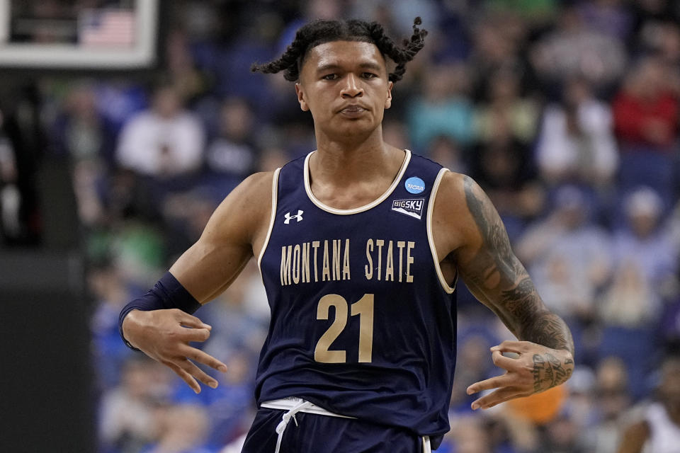 FILE- RaeQuan Battle celebrates after scoring for Montana State against Kansas State during the first half of a first-round college basketball game in the NCAA Tournament on , March 17, 2023, in Greensboro, N.C. Battle now attends West Virginia but has yet to play this season. College athletes like Battle who were denied the chance to play immediately after transferring a second time can return to competition, for now, after a federal judge issued a 14-day temporary restraining order Wednesday, Dec. 13, 2023, against the NCAA. (AP Photo/Chris Carlson, File)