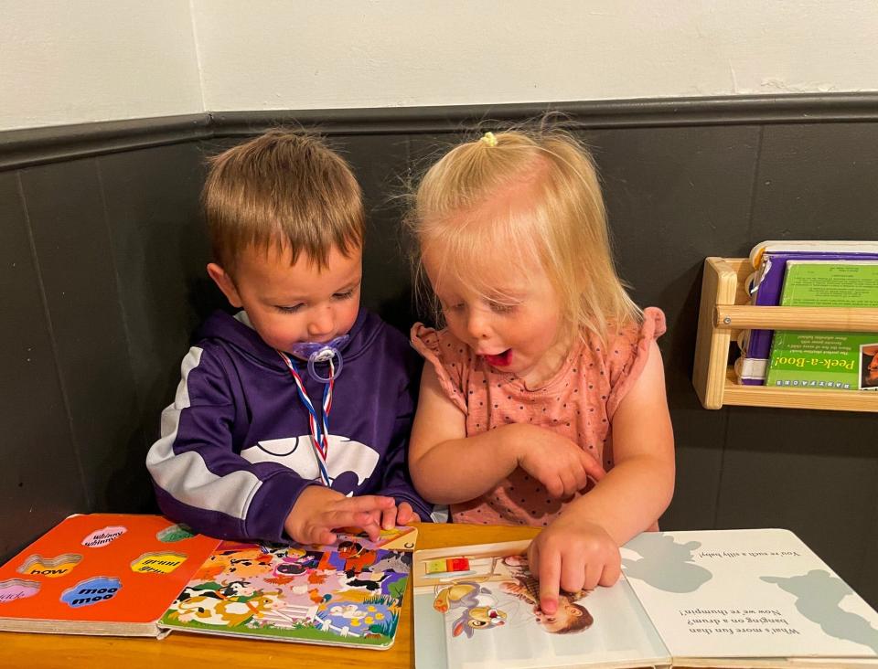 Axel Huff (left) and Brexley Biegert (right) read a book together at Eagle Wings Daycare home in Salina. A long-term goal of the new Early Childhood Initiative fund is to help at-home providers.