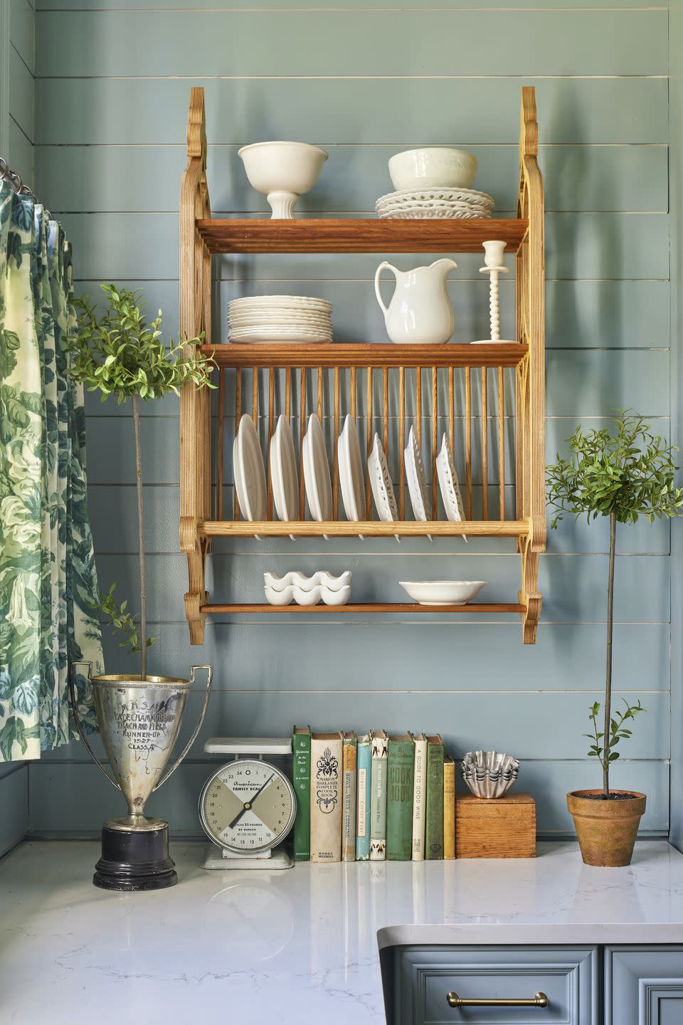 hanging plate rack in blue kitchen